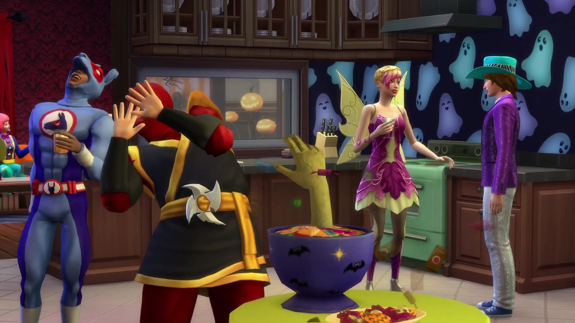 The Sims : des Sims en costumes d'Halloween dans une cuisine décorée avec des fantômes et des bonbons.